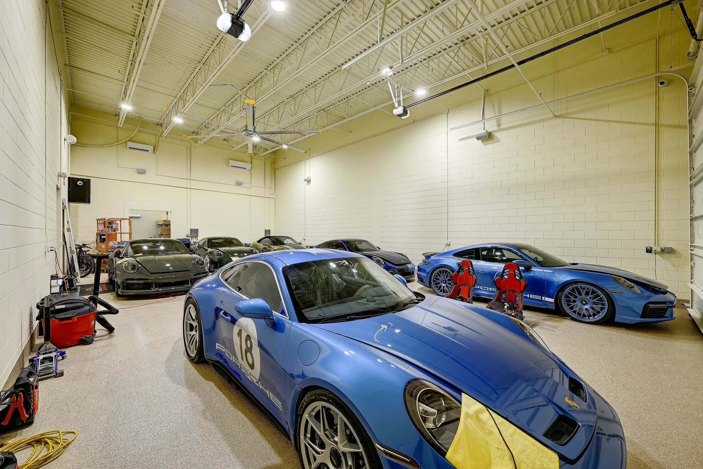A sports car collection with blue race-livery cars and red racing seats inside a Vehicle Fortress unit